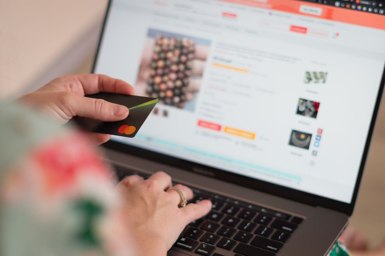 who-we-are Engaging in online shopping using a credit card with a laptop for convenience and ease.